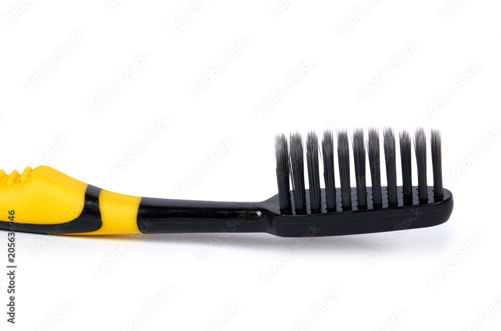 Black and yellow soft toothbrush isolated on white background Black and yellow soft toothbrush isolated on white background