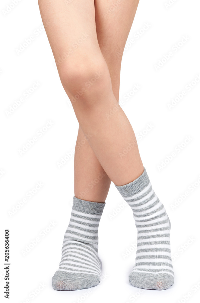 Kid legs in striped socks isolated on white background Kid legs in striped socks isolated on white background