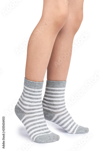 Kid legs in striped socks isolated on white background