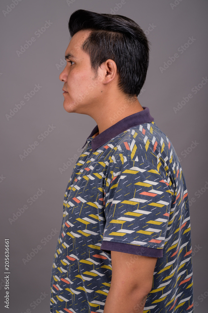 Young multi-ethnic man against gray background Young multi-ethnic man against gray background