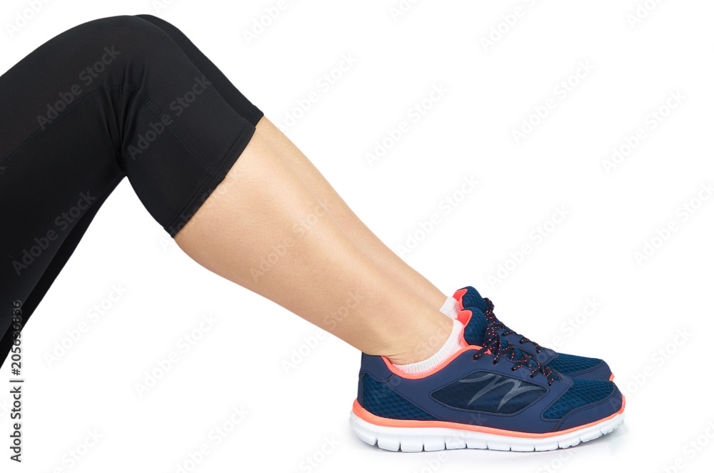 Fit female leg in sport shoe isolated on white background