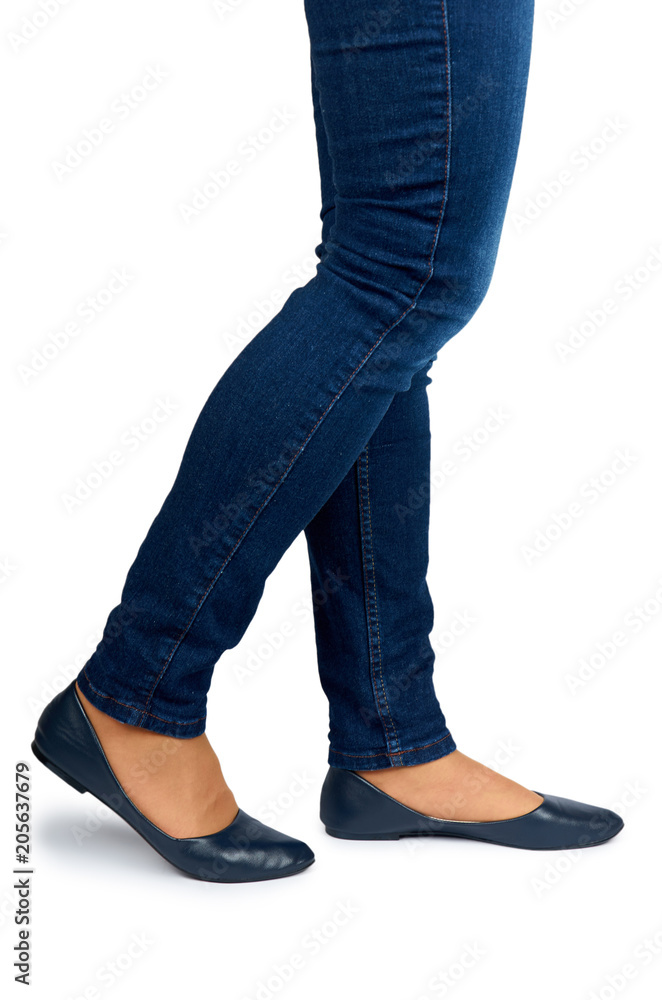 Female leg in jeans and leather shoes isolated on white background Female leg in jeans and leather shoes isolated on white background