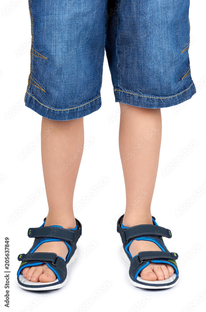 Kids leather sandals on leg isolated on a white background