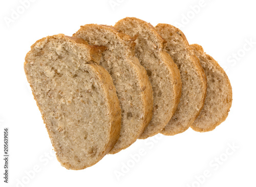 Top view of several slices of whole wheat bread loaf isolated on a white background.