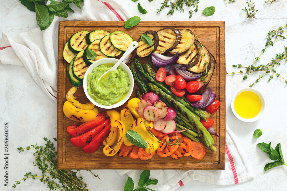 Summer grilled vegetables on wooden board, view from above