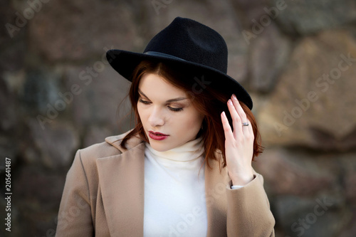 Lifestyle fashion portrait of young stylish hipster woman walking on the street. photo