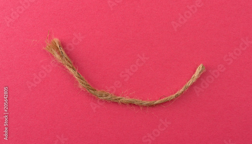 Piece of twine on red paper.