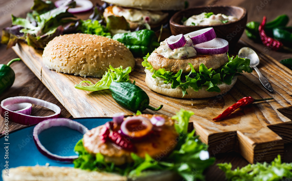 Chicken burgers with fresh salad, onion, peppers and mayonnaise sauce Chicken burgers with fresh salad, onion, peppers and mayonnaise sauce