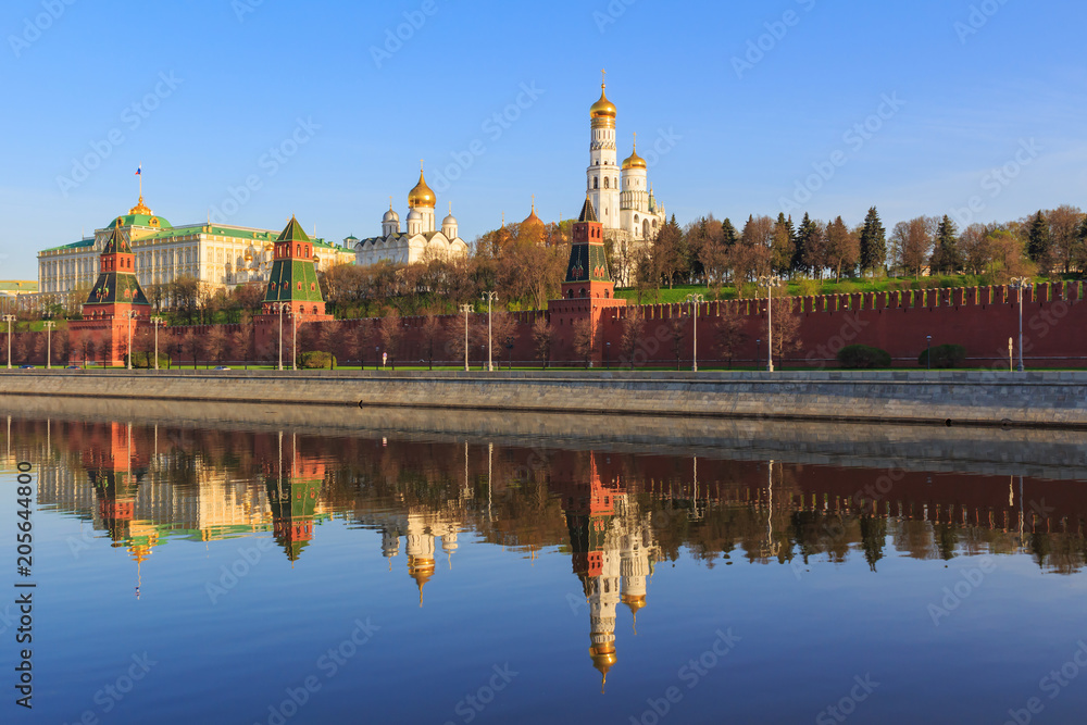 Reflections of Moscow Kremlin buildings on the water surface of Moskva river in spring sunny morning