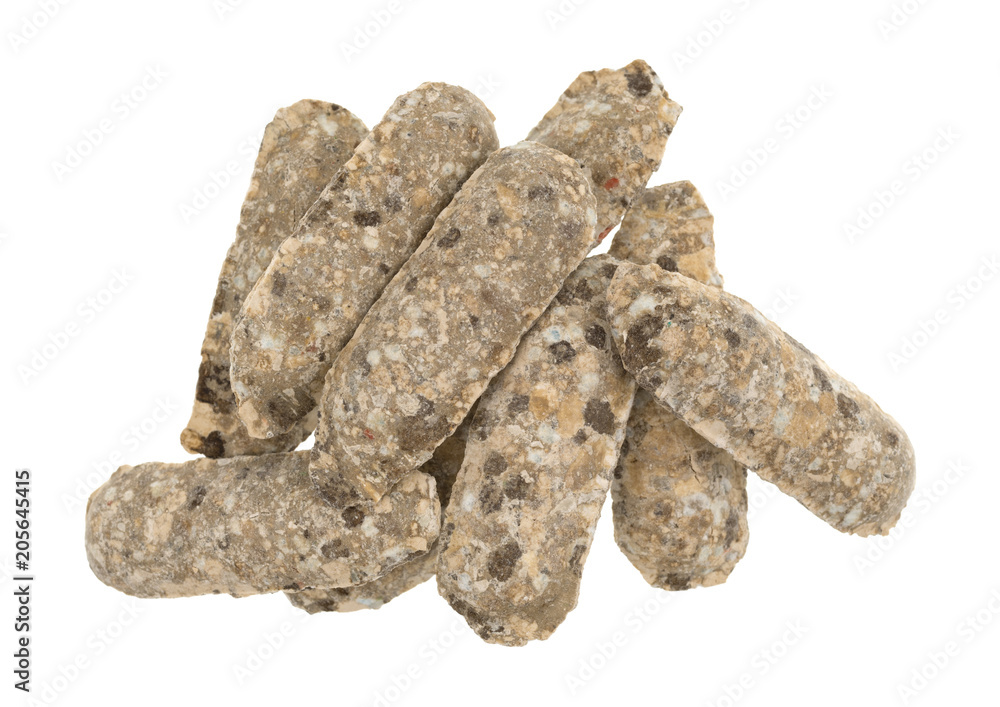 Top view of a pile of fertilizer spikes isolated on a white background.