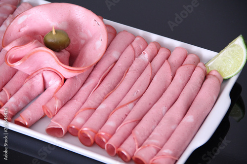 Bilde på lerret Mortadella, slaced, wrapped, olive, São Paulo, Brazil.