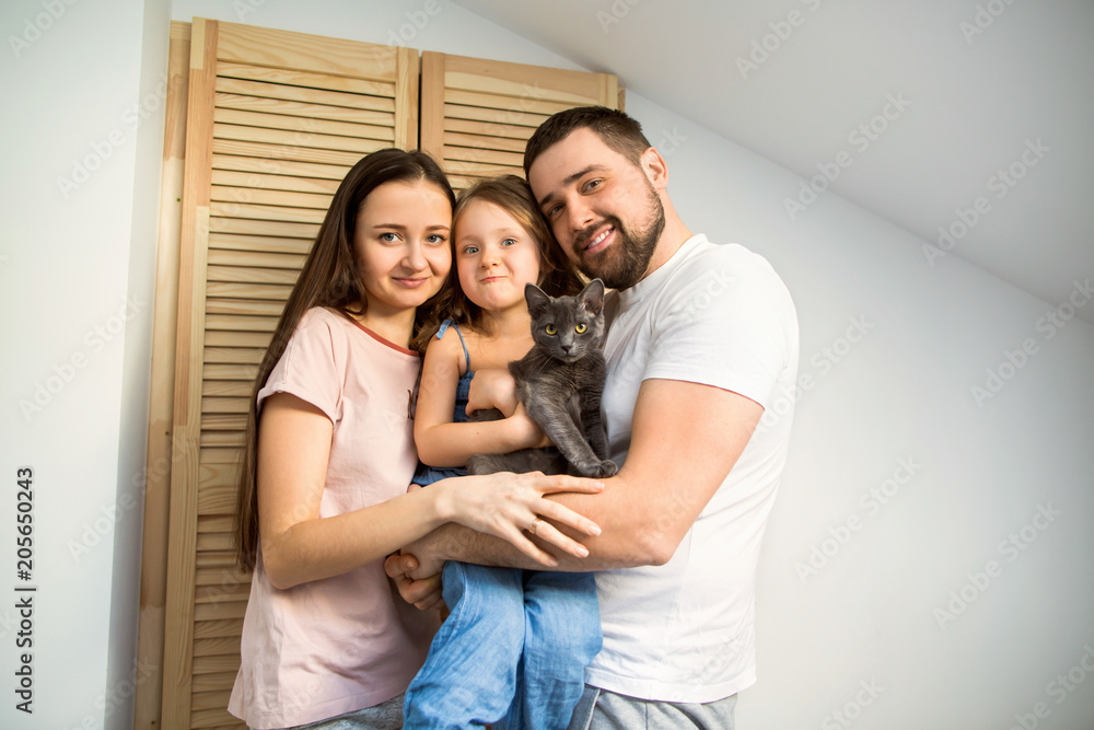 happy family at home in her room celebrating the fourth birthday of her daughter, present cat happy family at home in her room celebrating the fourth birthday of her daughter, present cat