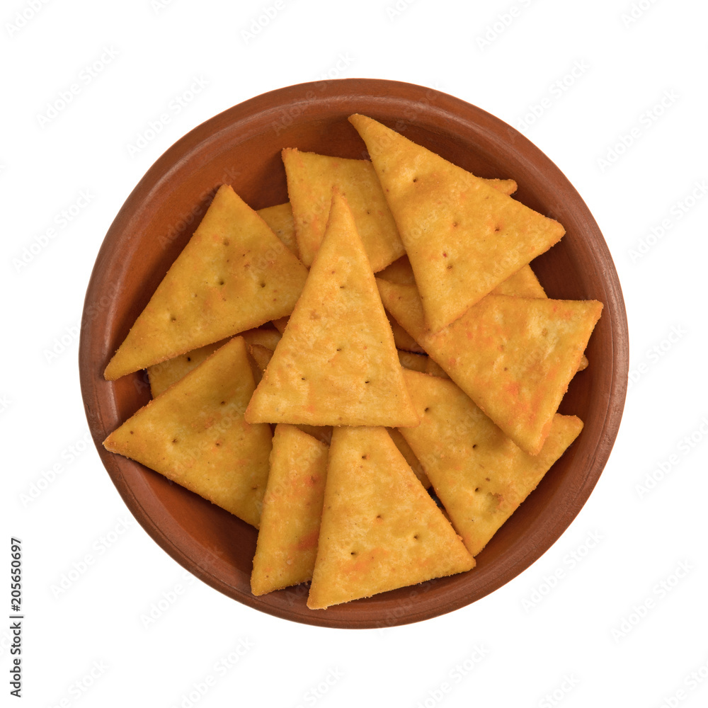 Top view of cheddar cheese snack crackers in a small bowl isolated on a white background. Top view of cheddar cheese snack crackers in a small bowl isolated on a white background.