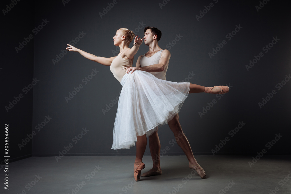 Naklejka premium Pair of young cute dancers training and doing support.