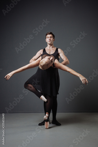 Fotografía Two young cute dancers moving graceful and man supporting ballerina