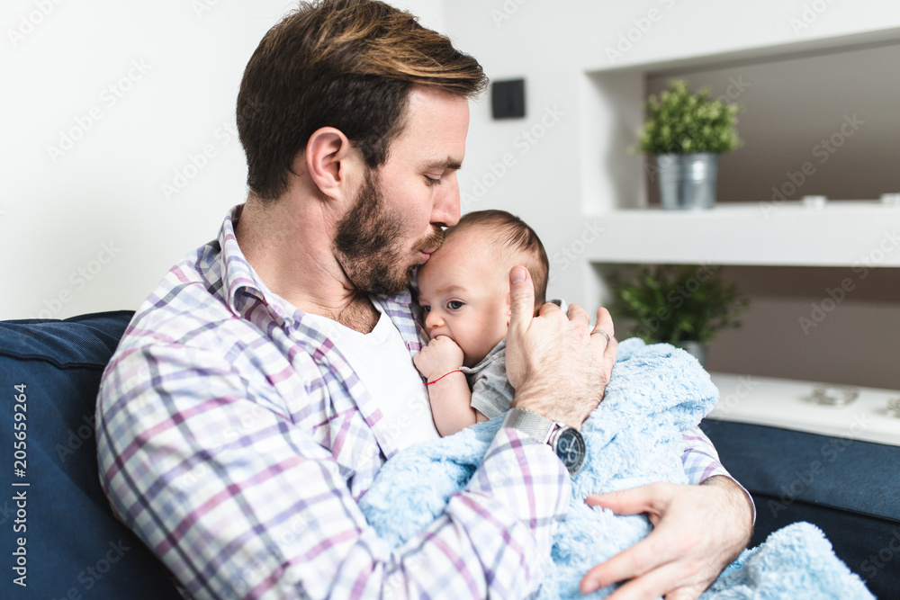Handsome father holding his cute little baby boy. Handsome father holding his cute little baby boy.