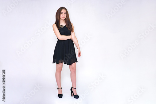 Portrait of a beautiful brunette girl on a white background in different poses.