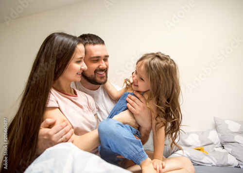 happy family at home in her room celebrating the fourth birthday of her daughter, concept of family relationships