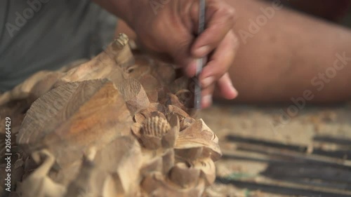 Asian wood carver working.