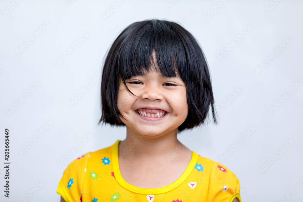 Studio portrait of Asian girl looking happy in front view Studio portrait of Asian girl looking happy in front view
