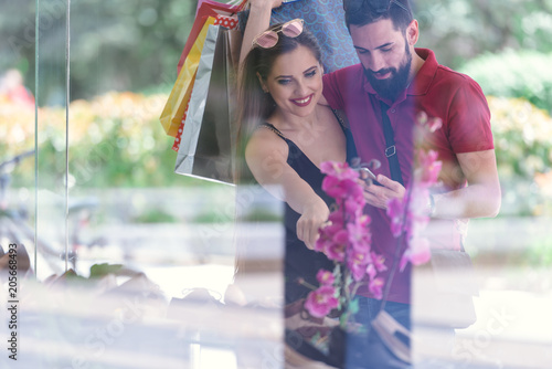 young couple window shopping at the mall photo