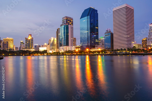 Bangkok city downtown at twilight with reflection of skyline, Benjakiti Park, Bangkok,Thailand © Naypong Studio