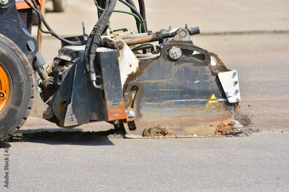 Professional machine car cuts the asphalt in the city Professional machine car cuts the asphalt in the city
