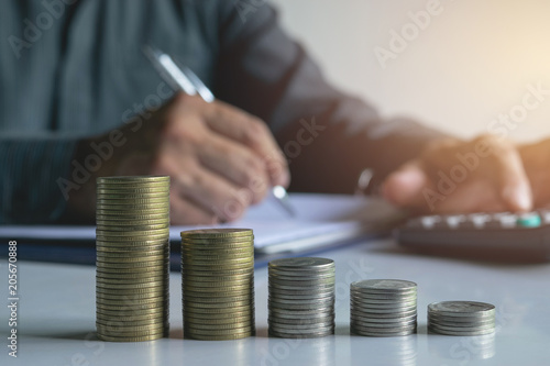 Men are Saint documents about cars with some coins calculator and car toy on desk