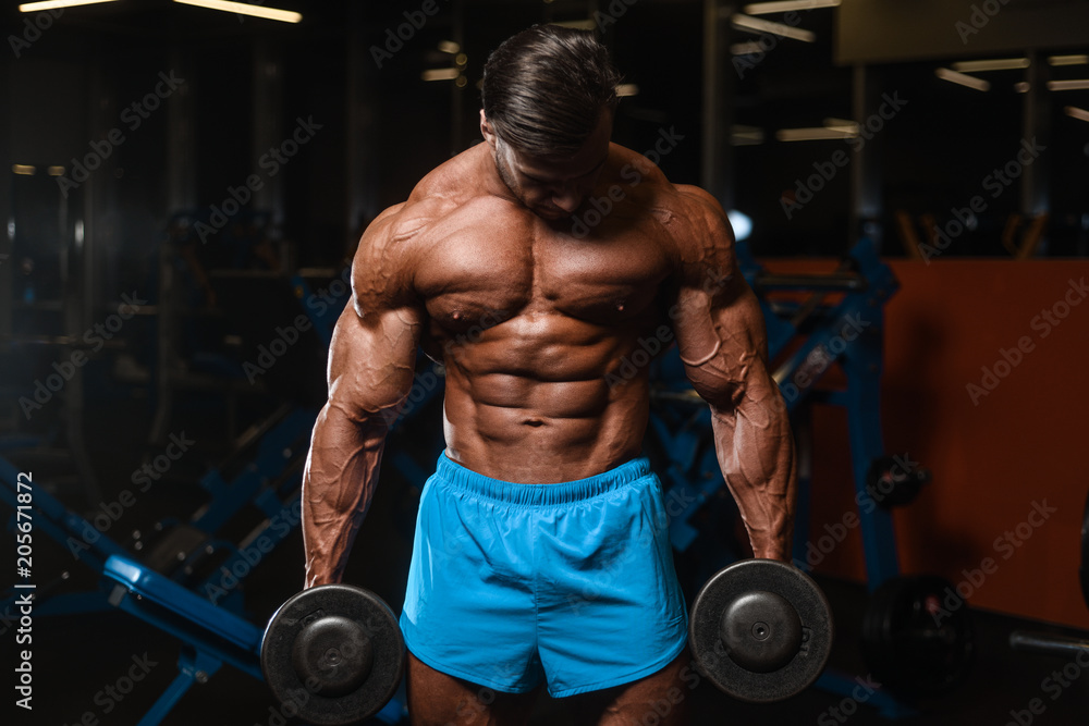 Handsome model muscle man abs workout in gym Handsome model muscle man abs workout in gym