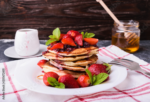 American pancakes with jam and fresh strawberries