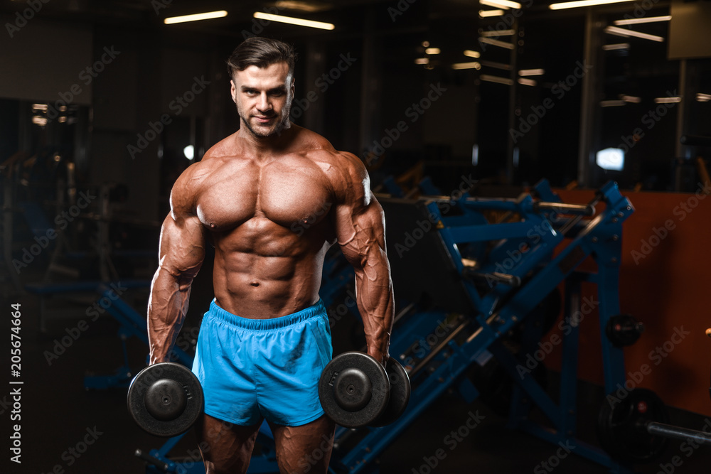 Fototapeta premium Handsome model muscle man abs workout in gym