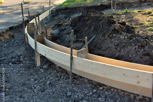 Wood forms installed ready for concrete pour for new curb and gutter.