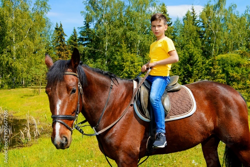 child is riding horse