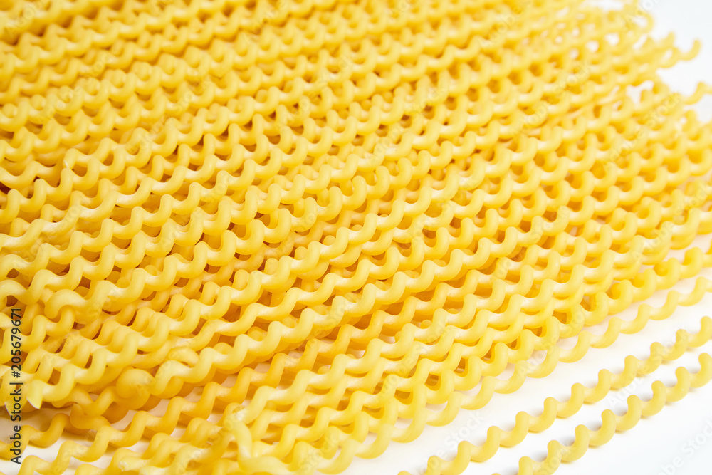 Raw fusilli bucati lunghi italian pasta on white background Raw fusilli bucati lunghi italian pasta on white background