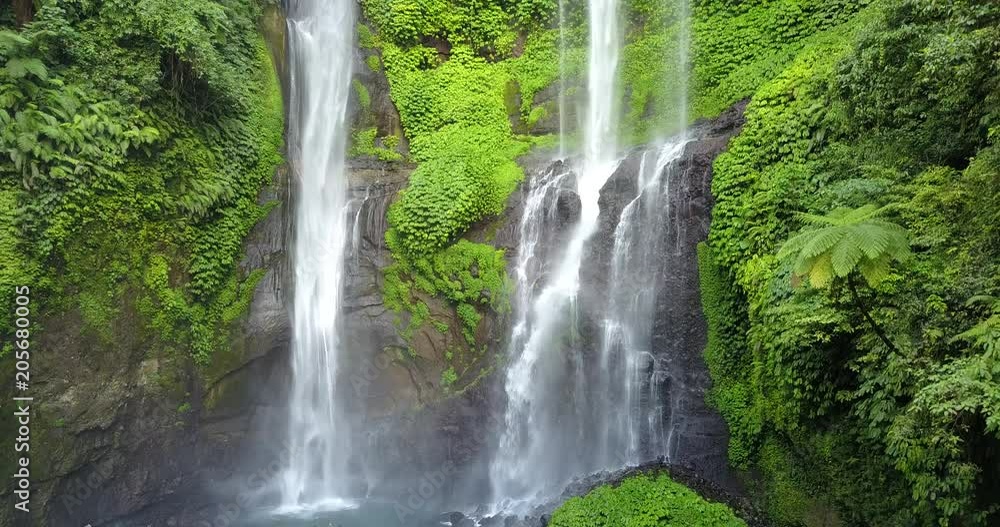 Sekumpul Waterfall in Bali with tourists, Indonesia . Drone aerial Shot Sekumpul Waterfall in Bali with tourists, Indonesia . Drone aerial Shot