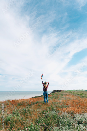 a girl with fireworks in her hands, is preparing to launch missiles in honor of the Independence Day celebration on July 4