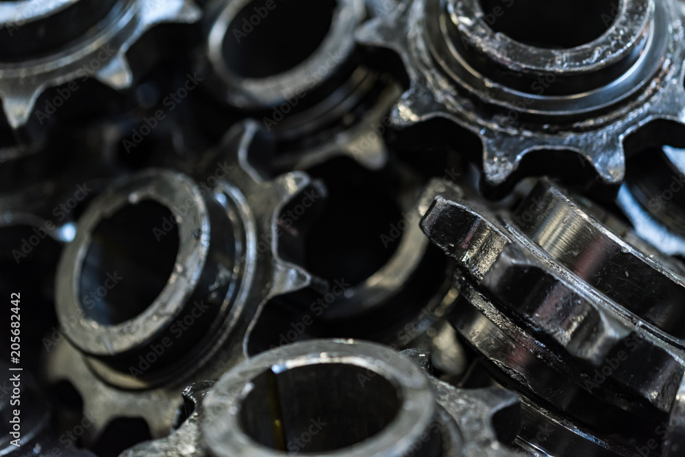 Background made of black spur gears or cogwheels Background made of black spur gears or cogwheels