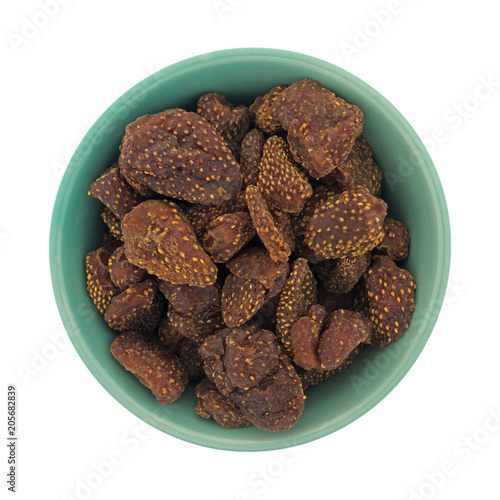 Top view of dried strawberries in a green bowl isolated on a white background.