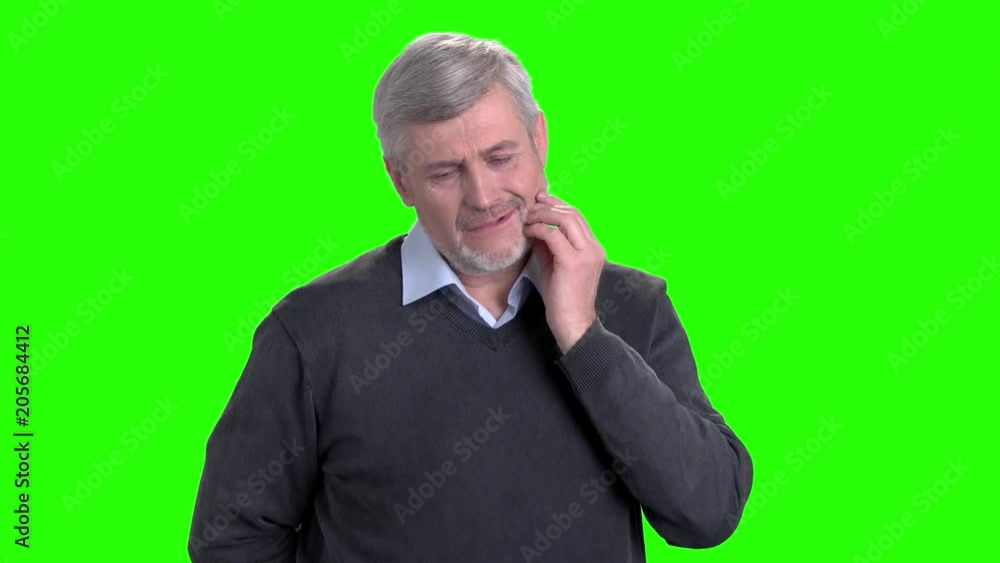Mature man suffering from tooth ache. Middle-aged man touching his cheek because of severe toothache on chroma key background. Mature man suffering from tooth ache. Middle-aged man touching his cheek because of severe toothache on chroma key background.