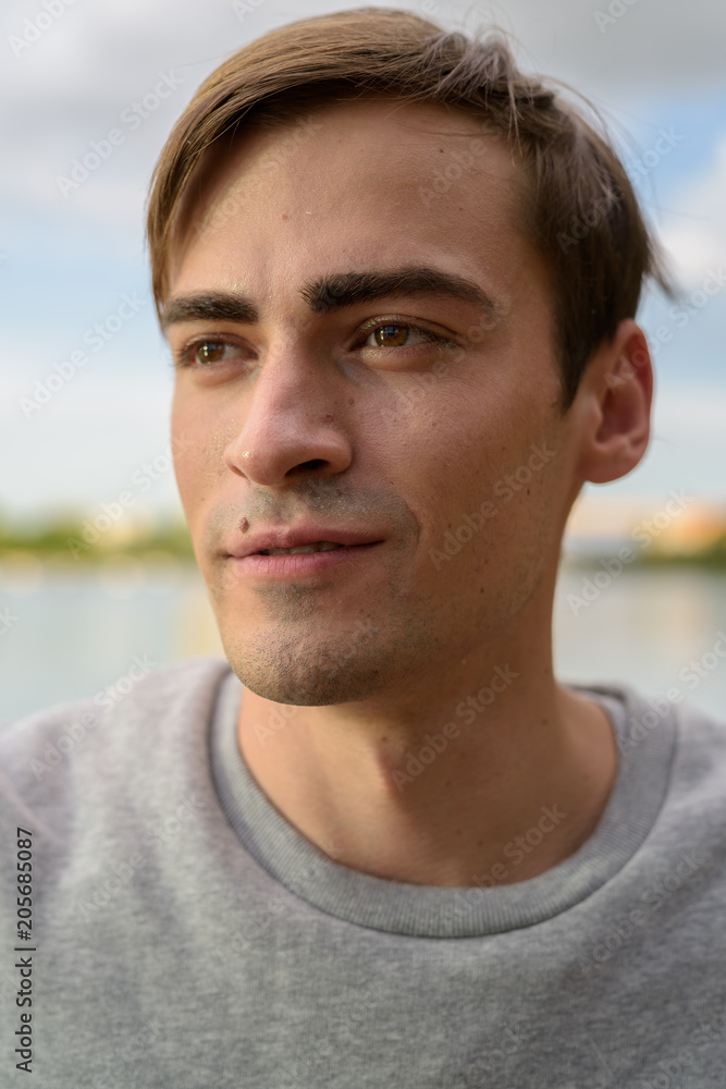 Fototapeta premium Young handsome man relaxing at the park