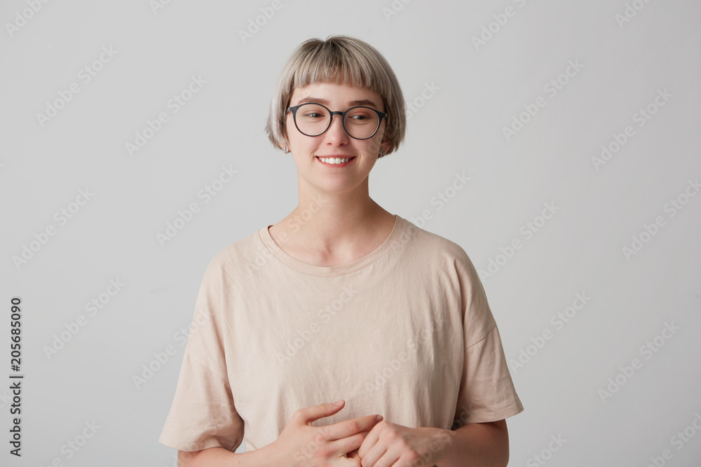 Happy cheerful young woman wears casual t shirt and glasses get a good news from her boyfriend aboit holidays. Postrait of smiling cute girl Happy cheerful young woman wears casual t shirt and glasses get a good news from her boyfriend aboit holidays. Postrait of smiling cute girl