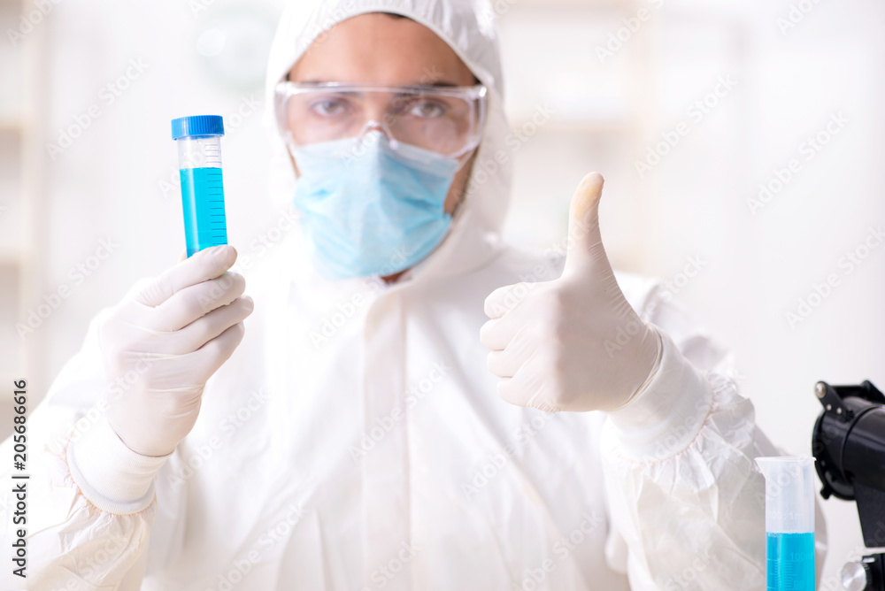 Young chemist student working in lab on chemicals Young chemist student working in lab on chemicals