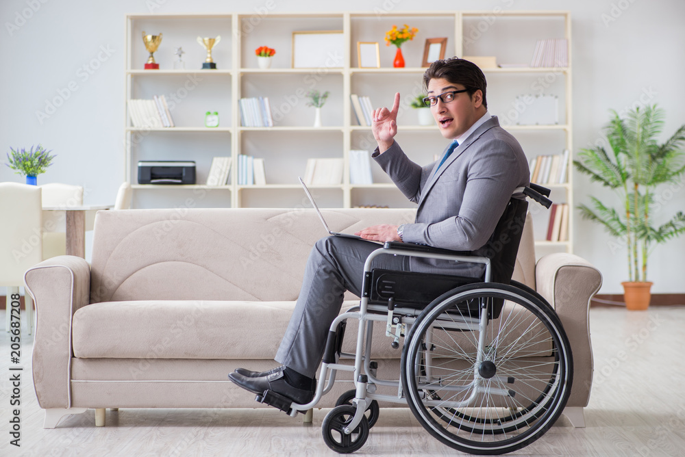 Dsabled businessman on wheelchair working home Dsabled businessman on wheelchair working home