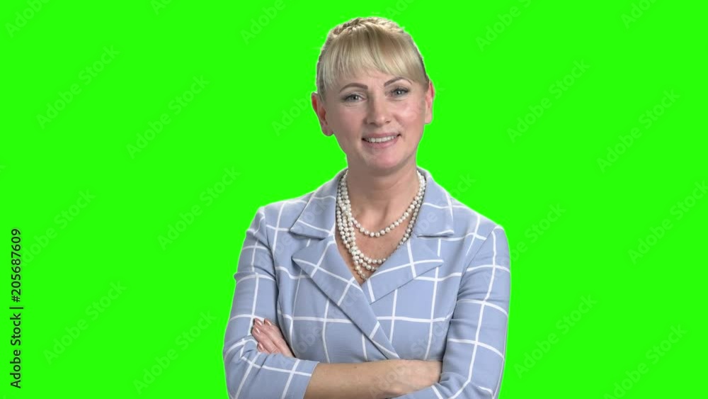 Elegant business woman on green screen. Attractive mature woman with arms crossed on Alpha Channel background. Feminine beauty and charm. Elegant business woman on green screen. Attractive mature woman with arms crossed on Alpha Channel background. Feminine beauty and charm.