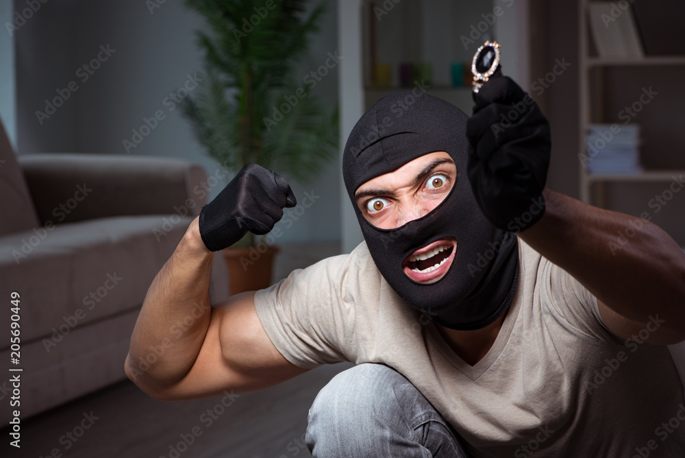 Burglar wearing balaclava mask at crime scene Burglar wearing balaclava mask at crime scene
