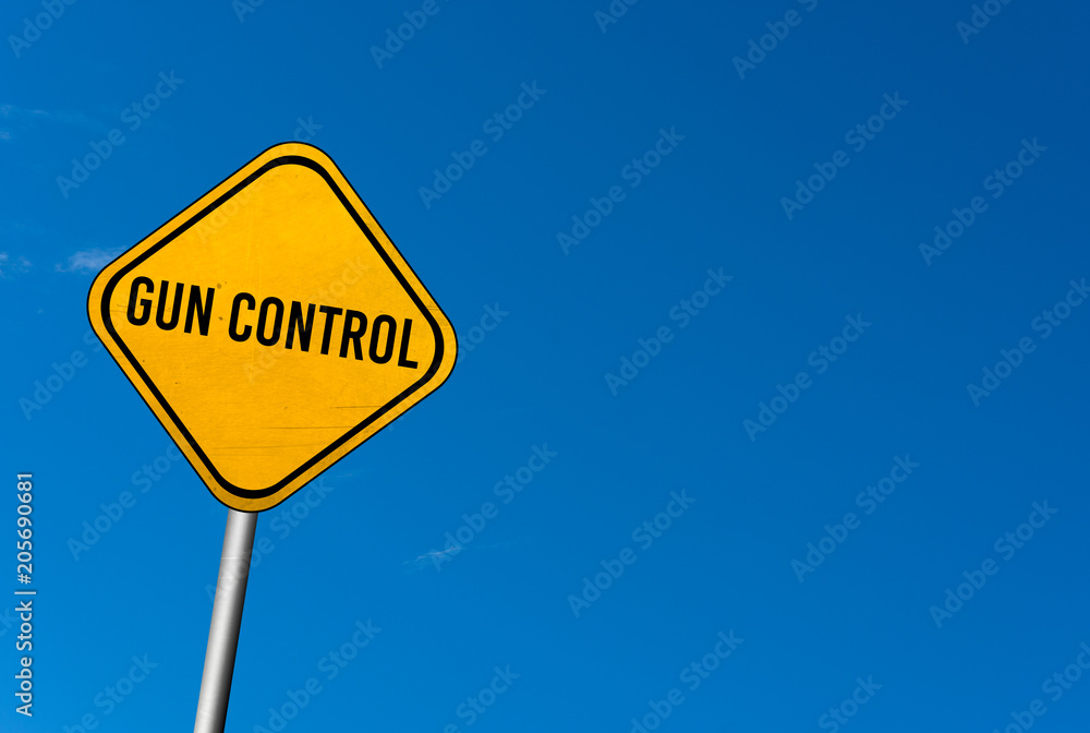 gun control - yellow sign with blue sky gun control - yellow sign with blue sky