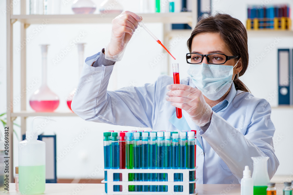 Female chemist working in hospital lab Female chemist working in hospital lab