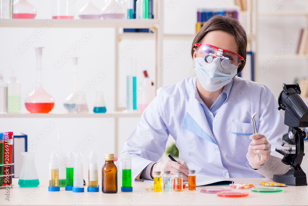 Lab assistant in drug synthesis concept Lab assistant in drug synthesis concept