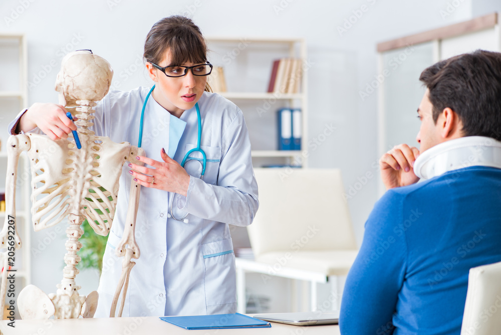 Fototapeta premium Doctor is explaining to patient with neck injury