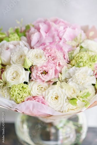 Floristry concept. Bouquet of beautiful flowers on gray table. Spring colors. the work of the florist at a flower shop.